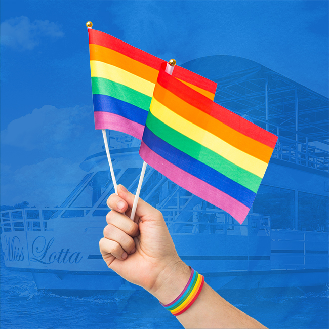Holding a rainbow flag in front Miss Lotta